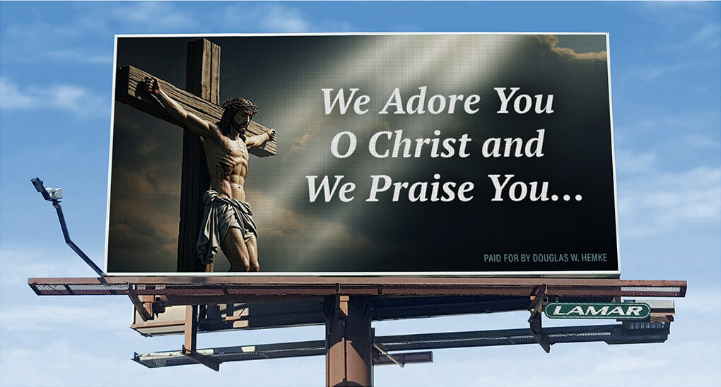 Outdoor billboard featuring Jesus on the cross with the words "We Adore You O Christ and We Praise You..." set against a blue sky.